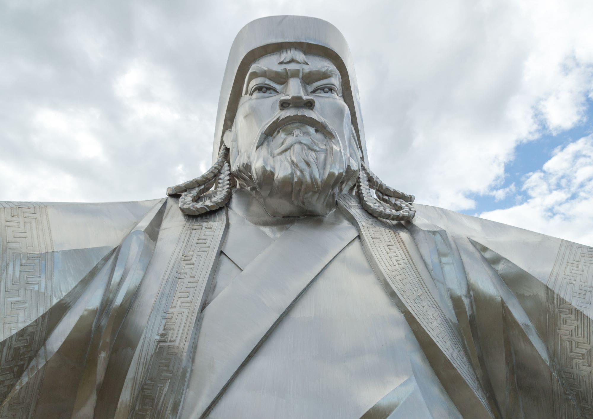 A close-up shot of a silver statue of Genghis Khan.