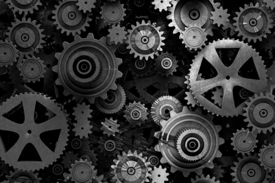 Black and grey industrial cogs of varying sizes.