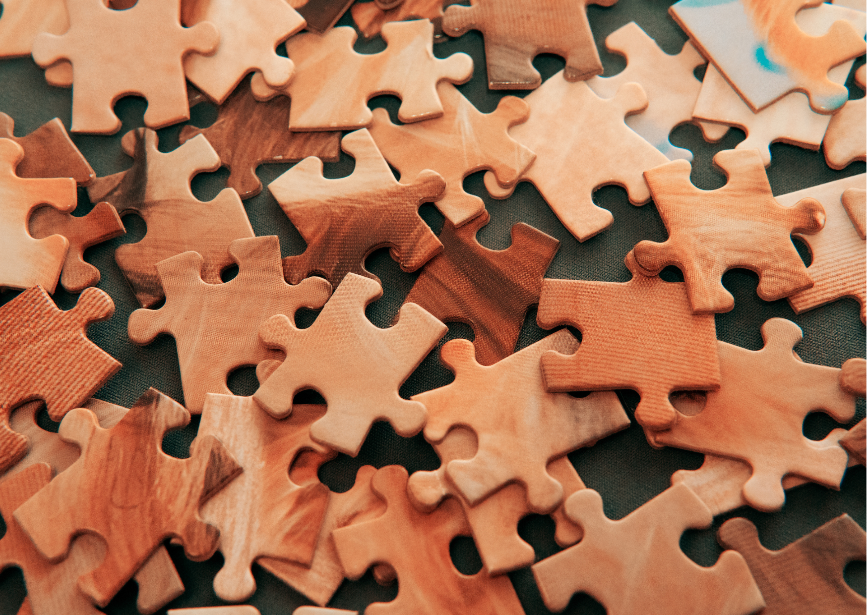 a pile of brown wooden puzzle pieces.