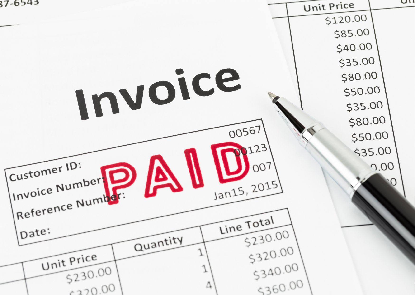 An invoice that has "Paid" stamped over it in red. There's a pen on the right.